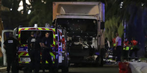 Police officers and rescued workers stand near a van that ploughed into a crowd leaving a fireworks display in the French Riviera town of Nice on July 14, 2016. The mayor of the French city of Nice said dozens of people were likely killed after a van rammed into a crowd marking Bastille Day in the French Riviera resort today and urged residents to stay indoors. / AFP / VALERY HACHE (Photo credit should read VALERY HACHE/AFP/Getty Images)